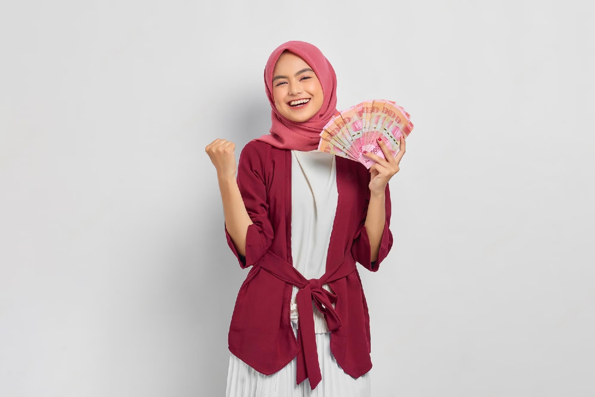 cheerful-beautiful-asian-woman-casual-shirt-hijab-showing-indonesian-rupiah-banknotes-celebrating-luck-isolated-white-background-people-religious-lifestyle-concept_512242-2172-transformed